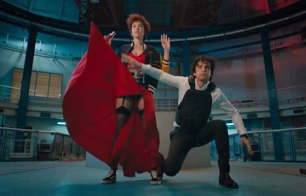 City Hunter and it's many amazing adaptions 39 A cinematic still showing characters Nicky and Laura in a dynamic combat pose, highlighting the action sequences in live-action City Hunter adaptions.