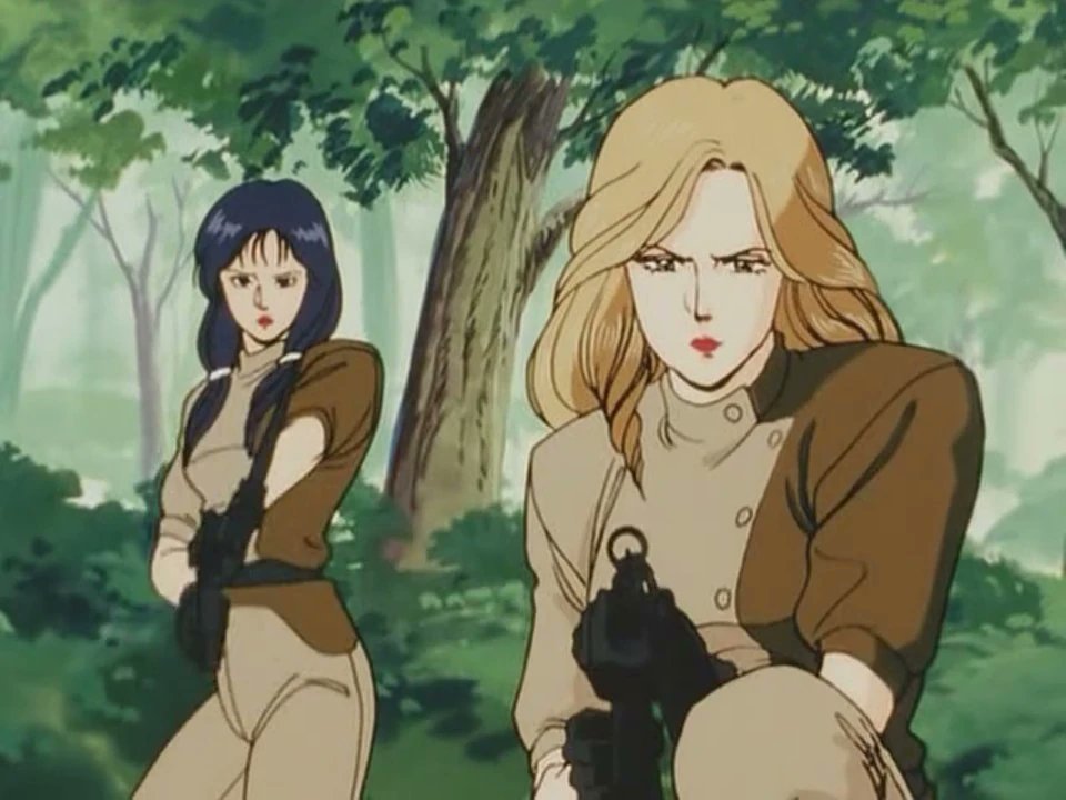 City Hunter and it's many amazing adaptions 28 An anime still showing two female characters in a forest setting, one holding a weapon, showcasing the animation style of early City Hunter adaptions.